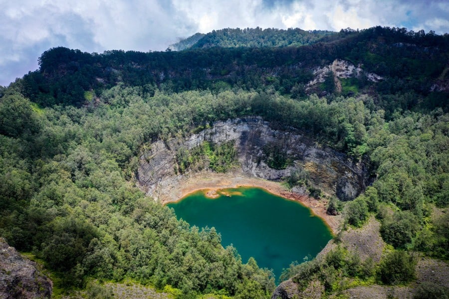The turquoise crater lake of Kelimutu with soft valley light