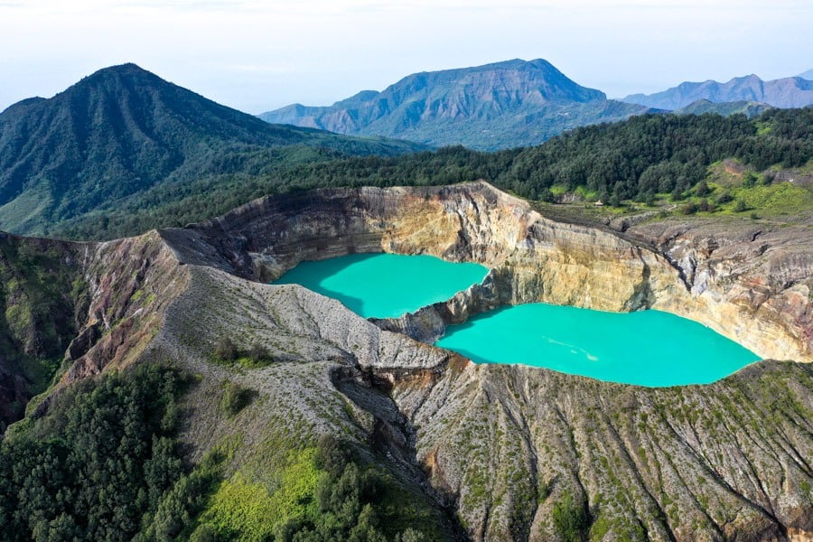 Aerial across the Kelimutu ridgeline and the lakes below