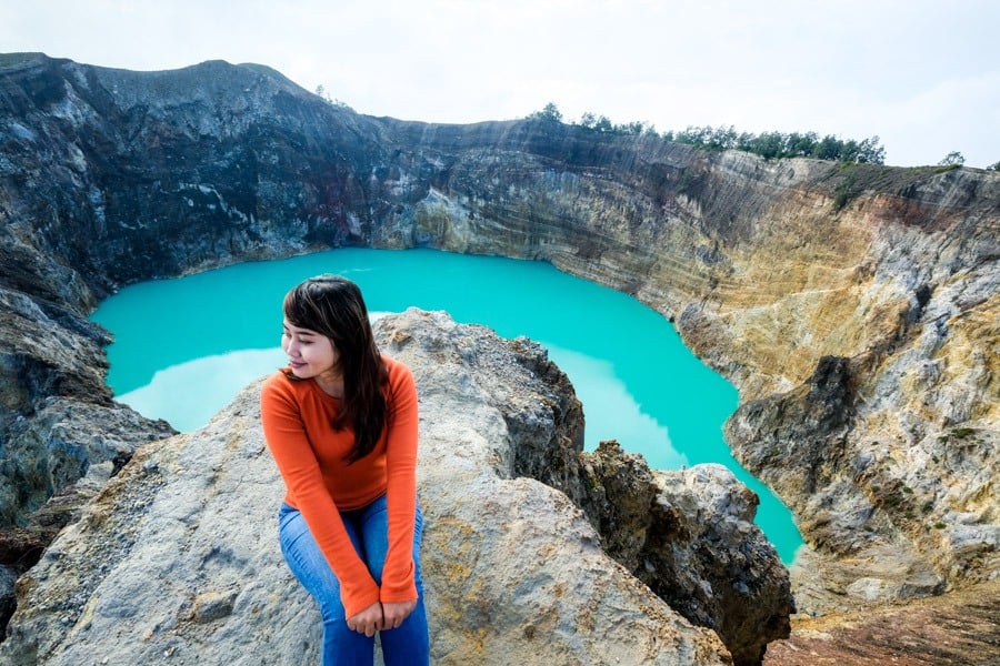Crater lakes of Kelimutu backed by the rolling Flores foothills